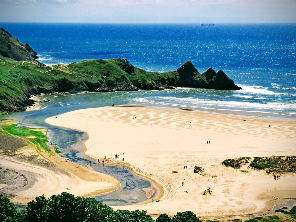 Three Cliffs Bay - stunning beach with green cliffs and ocean views